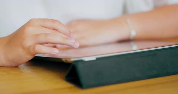 Closeup Focused Hands of Teen Girl with Bracelets on Wrists Who is Writing on Tablet Tablet is on