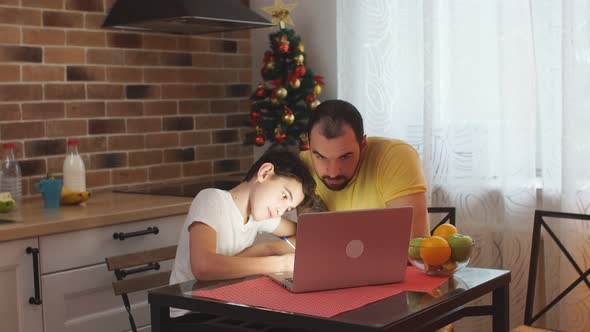 Young Father Helper and Studying Kid Boy at Home