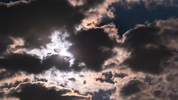 The Full Moon Rises in the Night Sky Over Dark Clouds. Timelapse