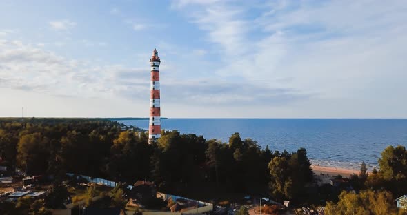 Old Active Lighthouse. Gloomy Sky and Cold Blue Atmosphere. Beach, North Misty Sea in Vintage