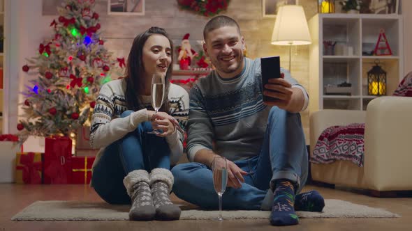 Cheerful Couple Drinking Champagne While Doing a Video Call