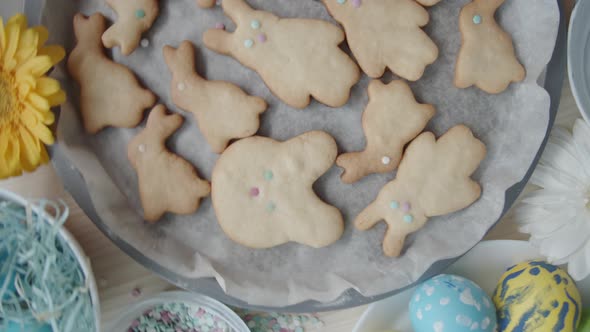 Top View of Easter Cookies and Colored Eggs on Table