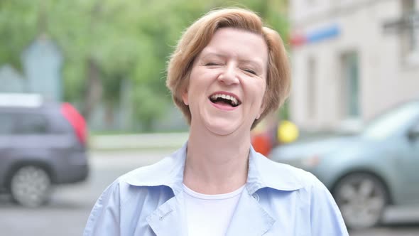 Portrait of Laughing Old Woman Standing Outdoor