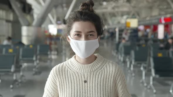 End of Pandemic. Portrait of Woman Put Off Medical Mask Looking Straight at Camera in Airport