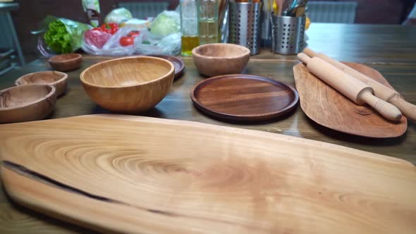 Kitchen Table with Wooden Utensils Cutting Boards and Rolling Pins