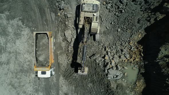 Excavators and Dump Trucks Working