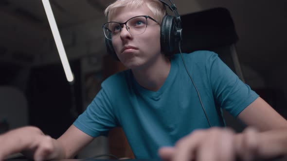 Caucasian Young Teen Guy Plays Games On Computer And Streams The Games Live