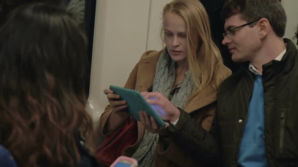 Subway Passengers Using Tablet PC