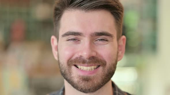 Close Up of Happy Young Man Looking at the Camera