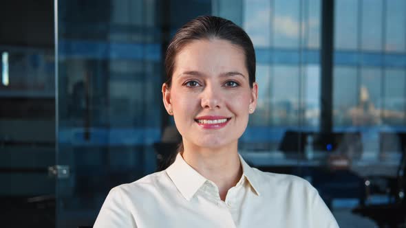 Smiling young businesswoman looking at camera
