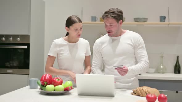 Mixed Race Couple Making Online Payment on Laptop