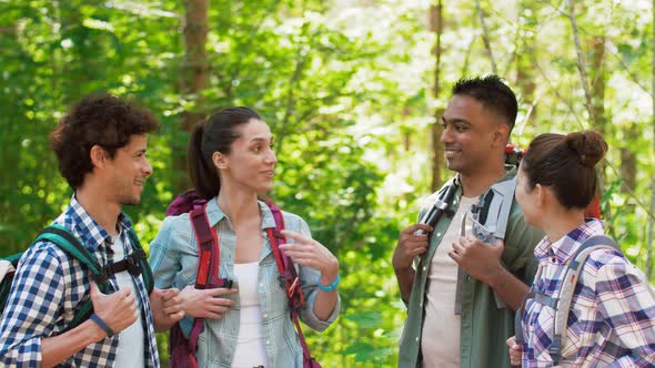 Friends with Backpacks Hiking and Making High Five