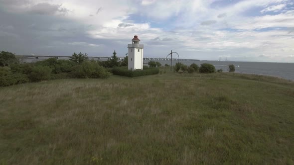 Lighthouse Drone Flies Low Towards Lighthouse End In A View Over Ocean