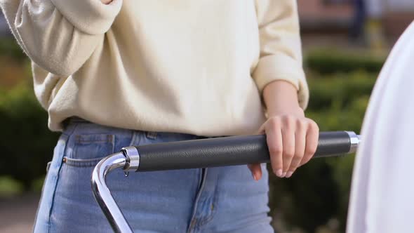 Mom Eating Fast Food, Strolling With Baby, Lacking Time to Prepare Healthy Food