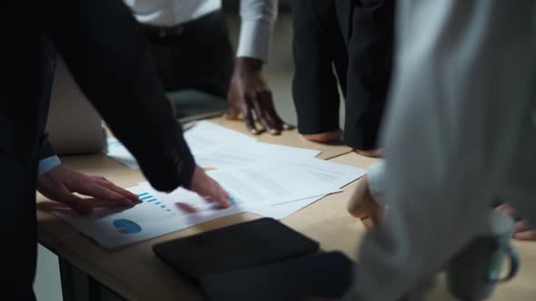 Business Meeting International Management Team at Work Team Is Standing Next To a Work Table and