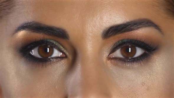 Girl with Beautiful Evening Make Up Often Blinks. Close Up