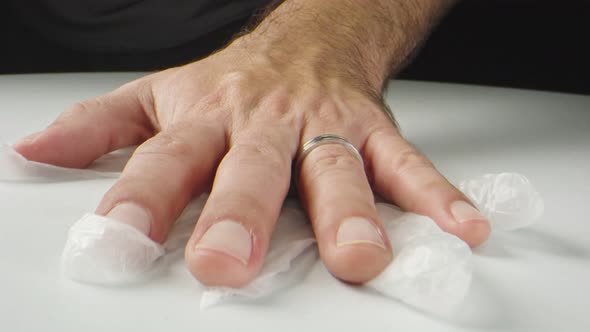 Macro Shot of Man's Hands Moving Gloves Toward Camera