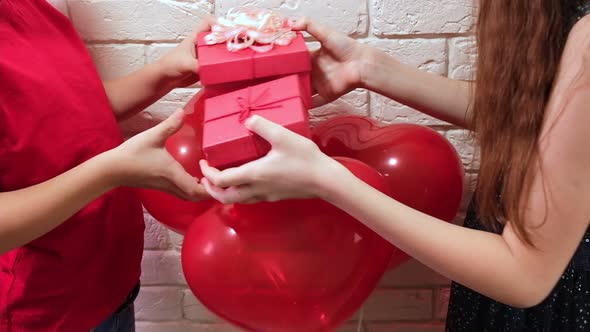 Little Boy and Girl Gives Valentines Day Gift Boxes