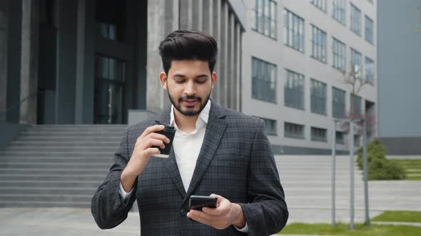 Arabian Man in Business Suit Standing Near Office Building with Modern