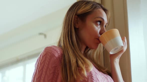 Thoughtful woman having coffee 4k