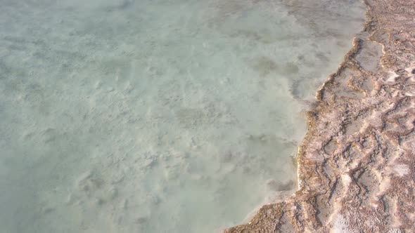 Transparent Clear Water in Natural Travertine Pool Close Up