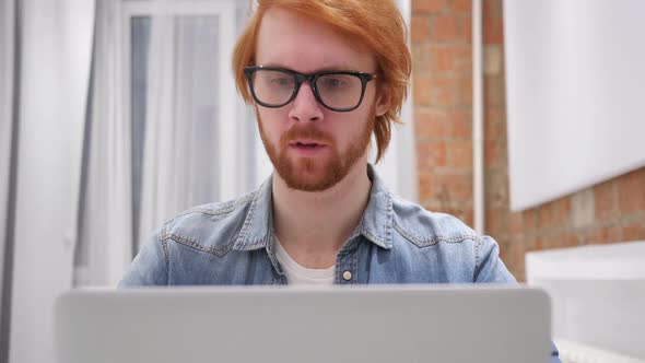 Upset Redhead Beard Man in Bed Working on Laptop Reacting to Loss