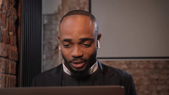 a Black Man Works at a Laptop Closeup of His Face