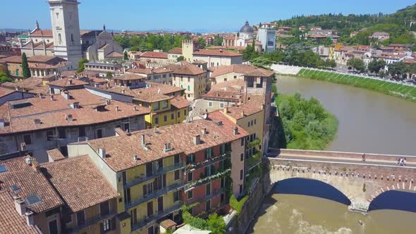 Panoramic aerial drone view of Verona, Italy. The drone moves away from the river Adige