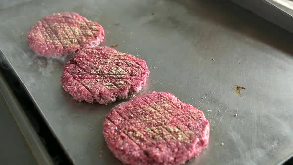 Grilling hamburger cutlets cooking in kitchen