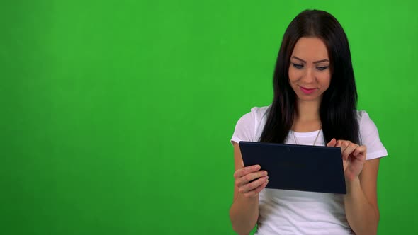 Young Pretty Woman Works on Tablet - Green Screen - Studio