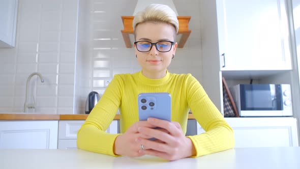 Tomboy person using modern smartphone for online communication in 4k stock video