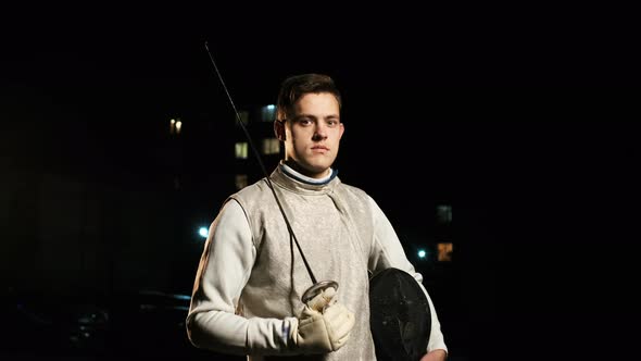 Portrait Of Young Fencer Man Looking Into Camera On The Street.