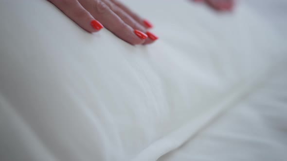 Closeup Clean White Bedding Indoors with Female Hand Stroking