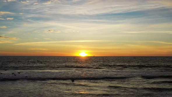 Splashing Ocean Waves With Beautiful Sunset Sky Background - aerial drone shot