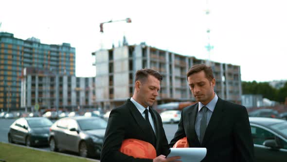 Two Architect Discuss New Building and Shows Thumbs Up