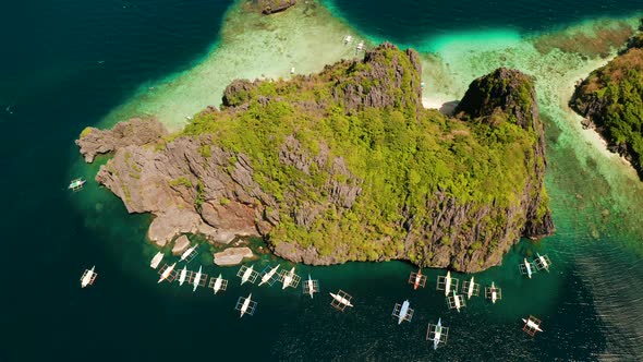 Aerial View of Boats and Limestone Cliffs