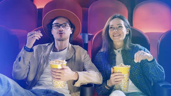 Young Man and Woman are Laughing at the Cinema