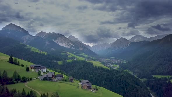 Fly Over a Small Mountain Village in the Dolomites in Italy