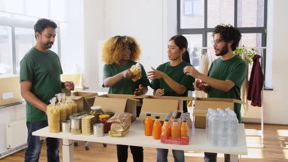 Happy Volunteers Packing Food in Donation Boxes