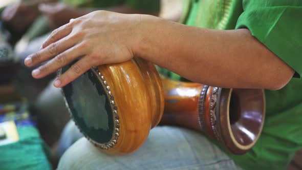 Focused Shot of Man's Arms As He Plays the Thai Hand Drums