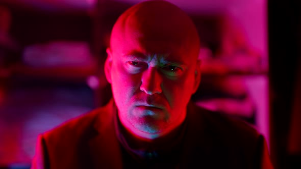 Serious Angry Man in Neon Light in Darkness Prohibiting Wagging Finger and Beckoning