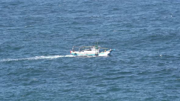 Fishing Trawler Fishing Boat Sailing in Deep Blue Ocean.