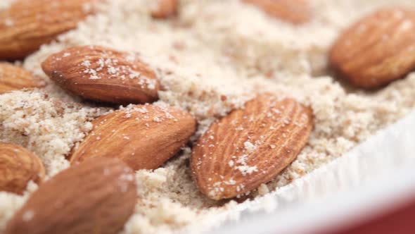 Almond Powder and Almond in a Jar on Table