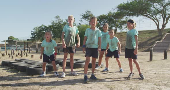 Group of Caucasian children training at boot camp