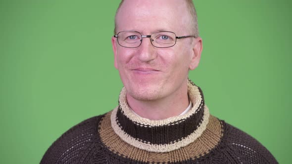 Happy Mature Bald Man with Turtleneck Sweater Thinking