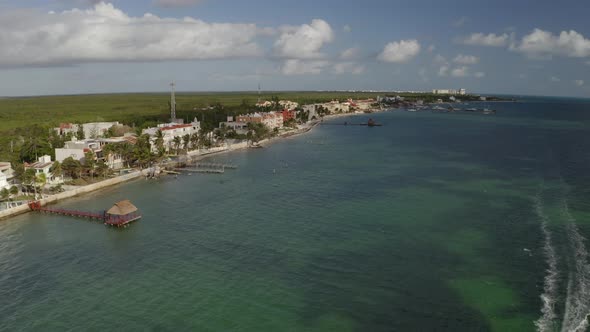 Aerial drone backward moving shot of hotels and resorts with the wooden piers along the beach in Can