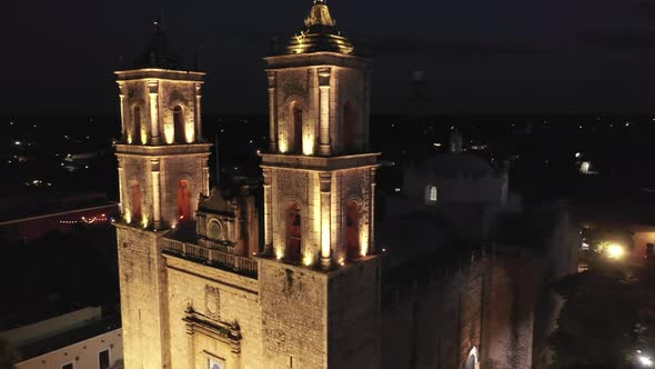 Aerial closeup nighttime orbit around the front of the Cathedral de San Gervasio in Valladolid, Yuca