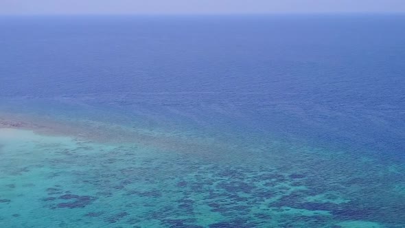 Aerial drone scenery of coast beach by blue sea with sand background