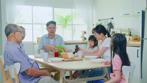 Asian big happy family have lunch on eating table together in house. Activity relationship concept.