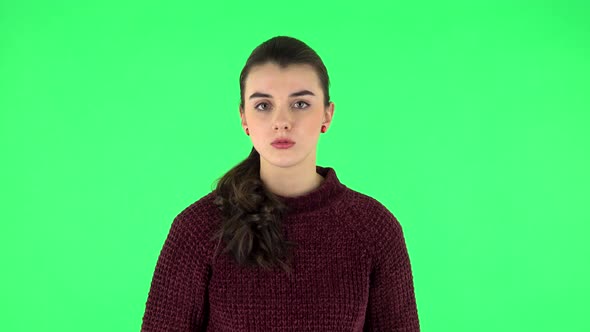 Girl Listens To Information Looking at Camera, Is Shocked and Very Upset. Green Screen